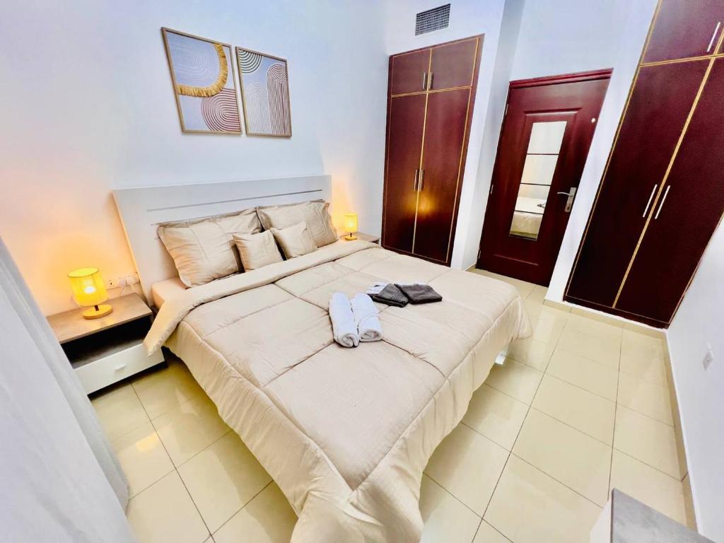 a bedroom with a large bed in a room at Cozy 2 Bedroom Apartment in Al Nahda Dubai in Dubai