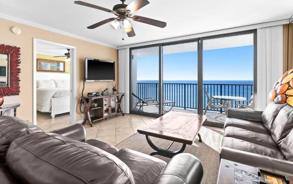 a living room with a couch and a ceiling fan at One Seagrove Place 1606 in Santa Rosa Beach