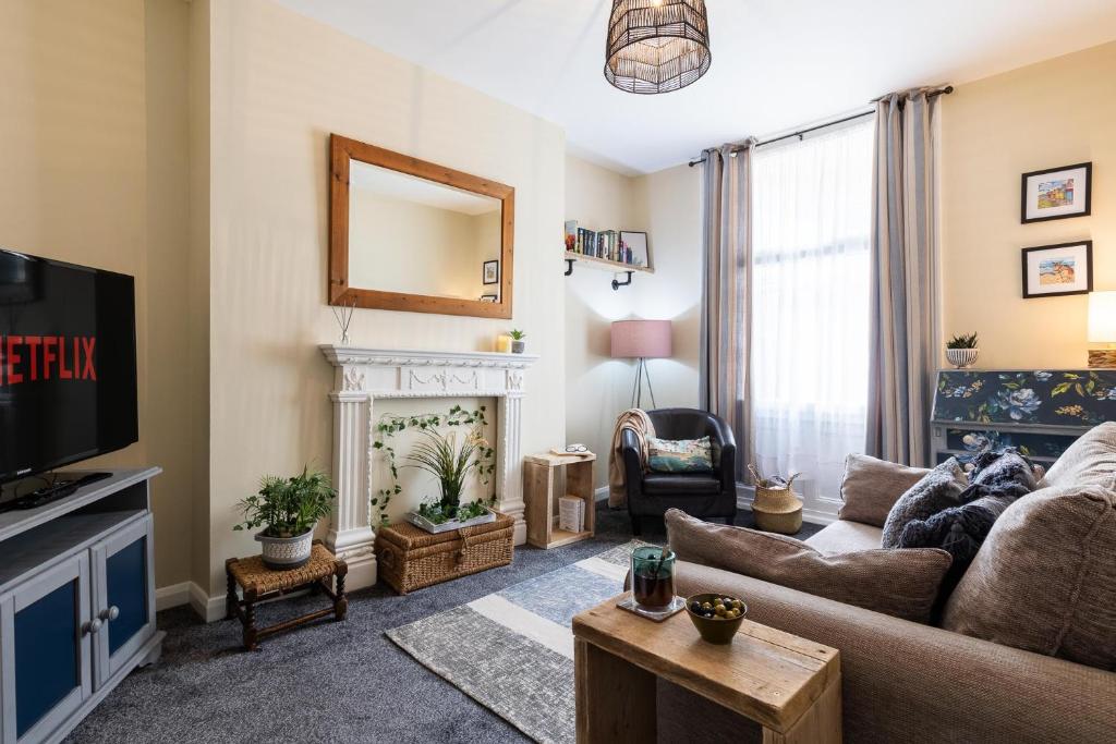 uma sala de estar com um sofá e uma lareira em Castle Bay Apartment em Scarborough