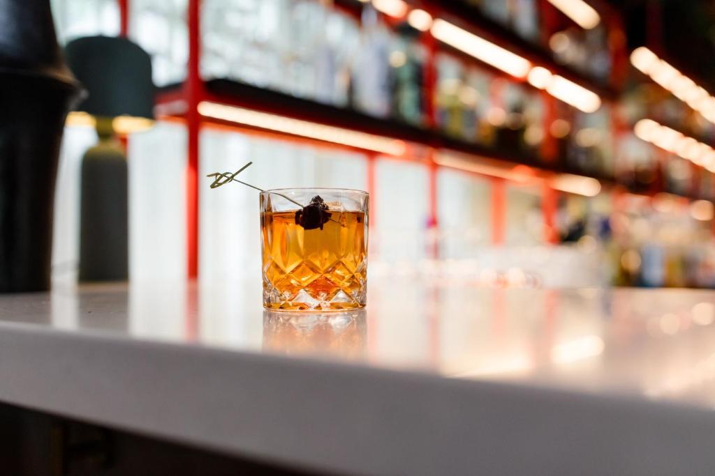 a glass of whiskey sitting on a counter in a store at Buffalo Mountain Lodge in Banff