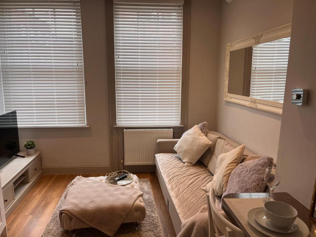 a living room with a couch and a table at Central private 1 bed flat in Reading