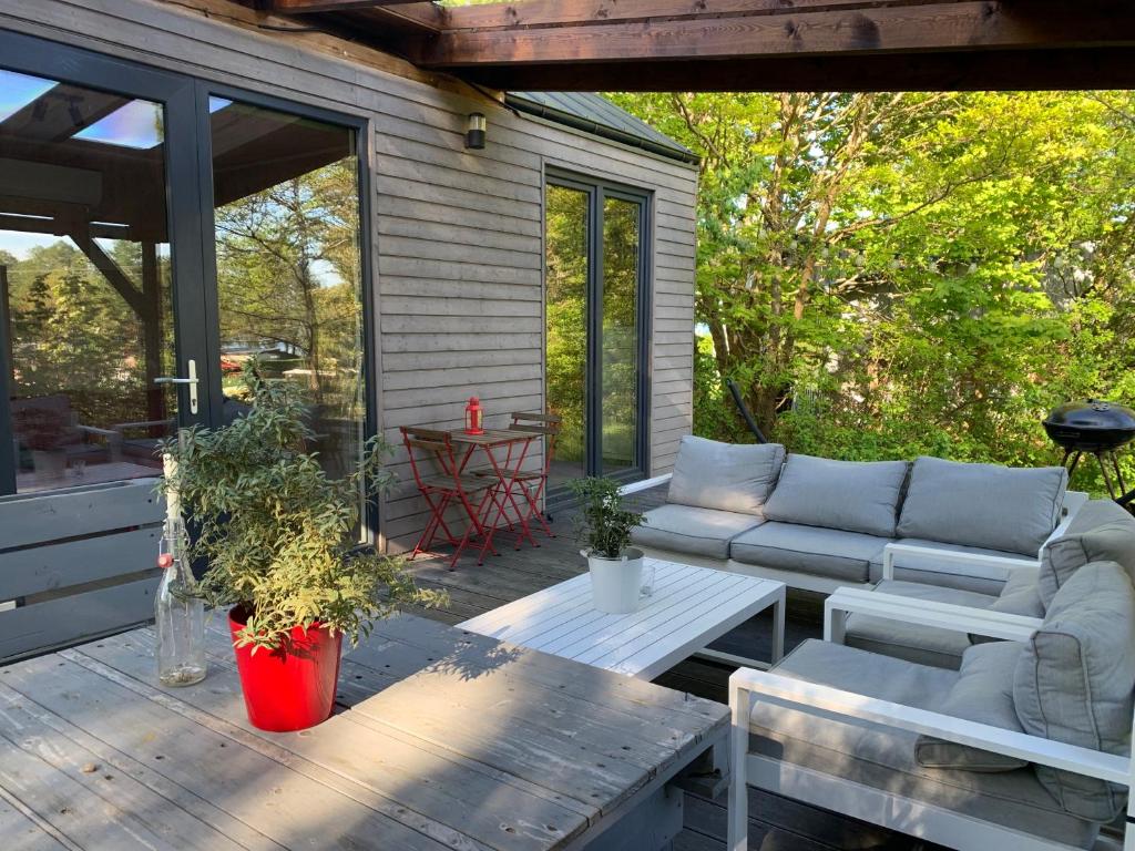 a screened in porch with a couch and a table at POLA in Łupawsko