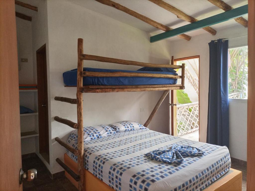 ein Schlafzimmer mit Etagenbetten in einem Zimmer mit Fenster in der Unterkunft Casaione in Puerto Colombia