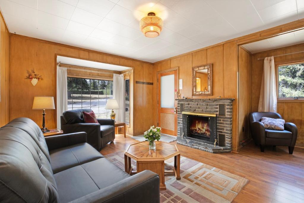 a living room with a couch and a fireplace at Elkhorn Lodge in Banff