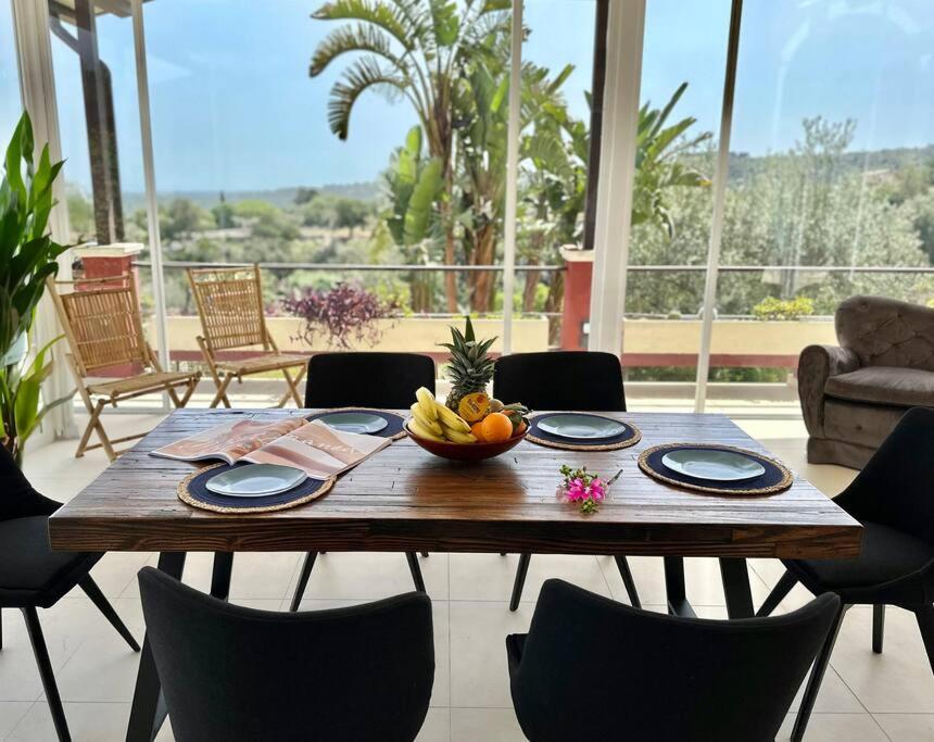 a wooden table with a bowl of fruit on it at Enchantment in the Heart of Nature in Canicattini Bagni