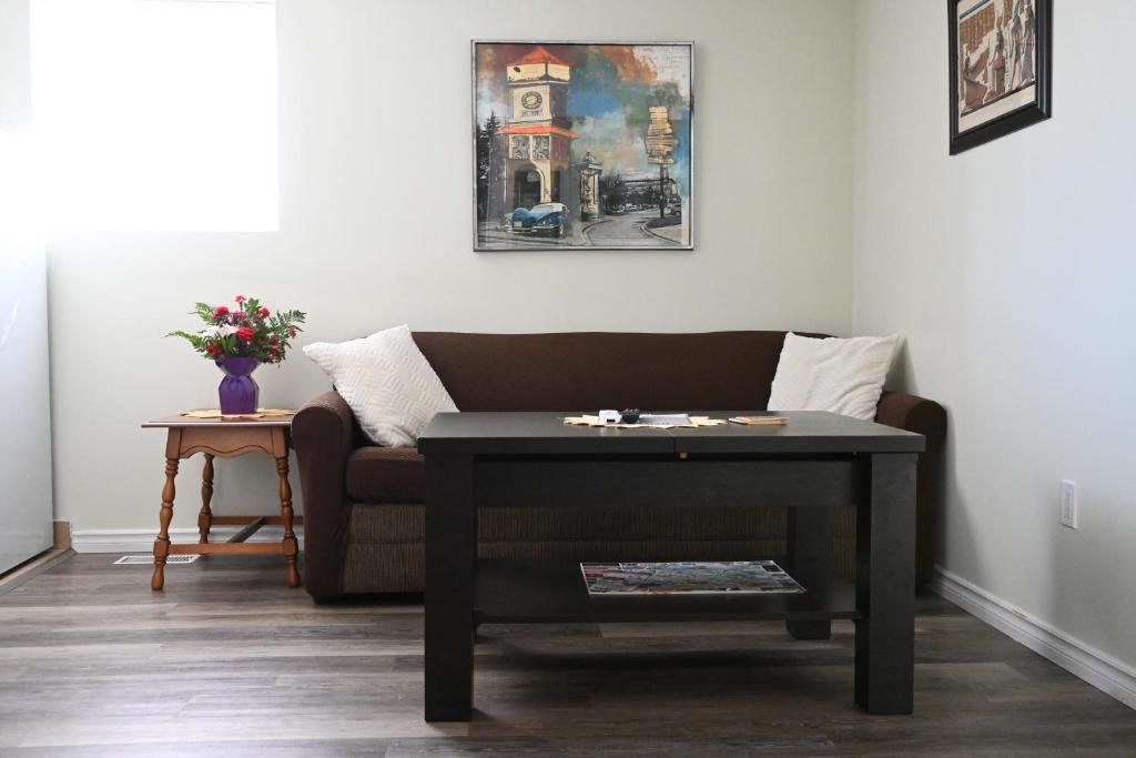 a living room with a couch and a table at Oasis Suite in Niagara Falls