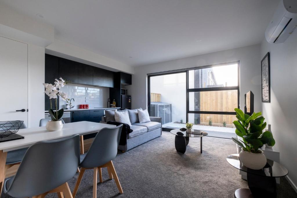 a living room with a couch and a table at Luxury 2 bed townhome in CBD in Christchurch