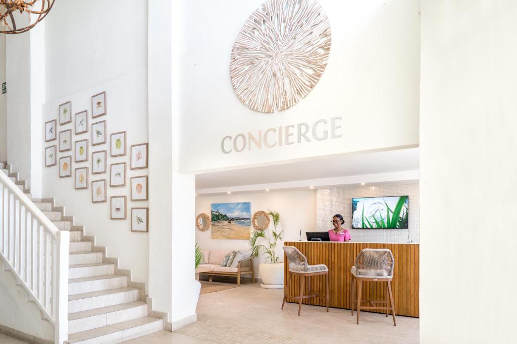 a woman sitting at the counter of a conference room at Sugar Bay Barbados - All Inclusive in Bridgetown