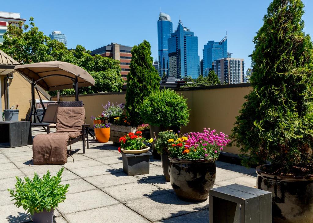 a patio with potted plants and a city skyline at HI Vancouver Downtown - Hostel in Vancouver