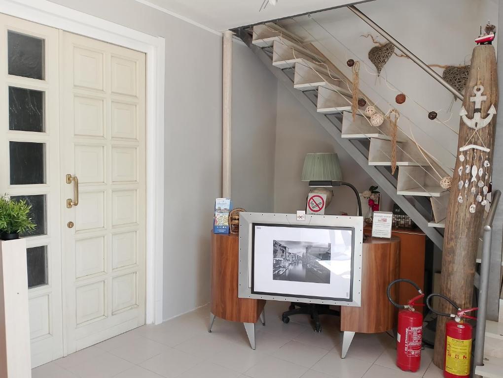 a living room with a tv and a staircase at Alloggi Adamo Venice in Oriago Di Mira