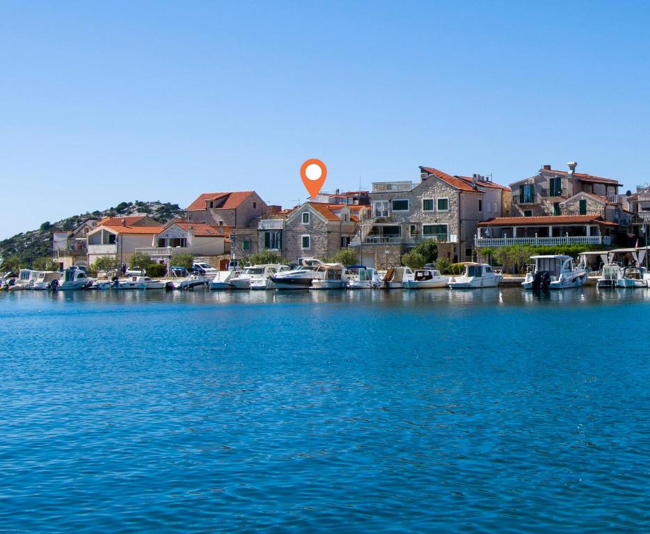 a large body of water with houses and boats at House Olivera in Tribunj