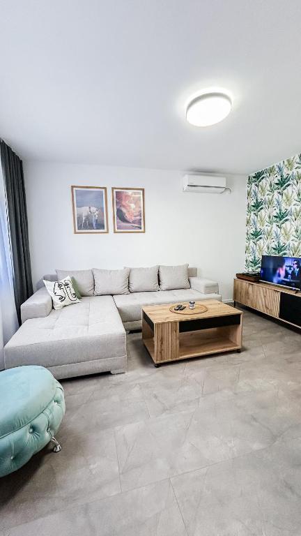 a living room with a couch and a coffee table at Moja Vojvodjanka in Gornja Rogatica