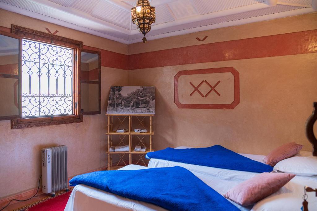 Postel nebo postele na pokoji v ubytování Riad Tourtit