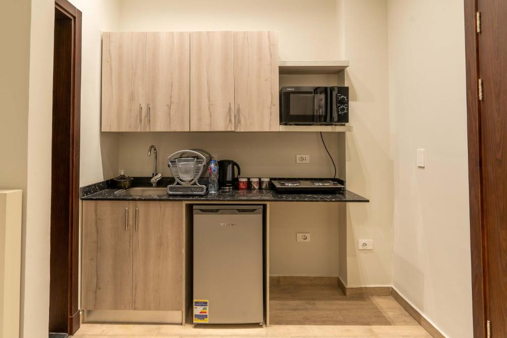 Kuchyň nebo kuchyňský kout v ubytování Sleep Inn Apart-Hotel