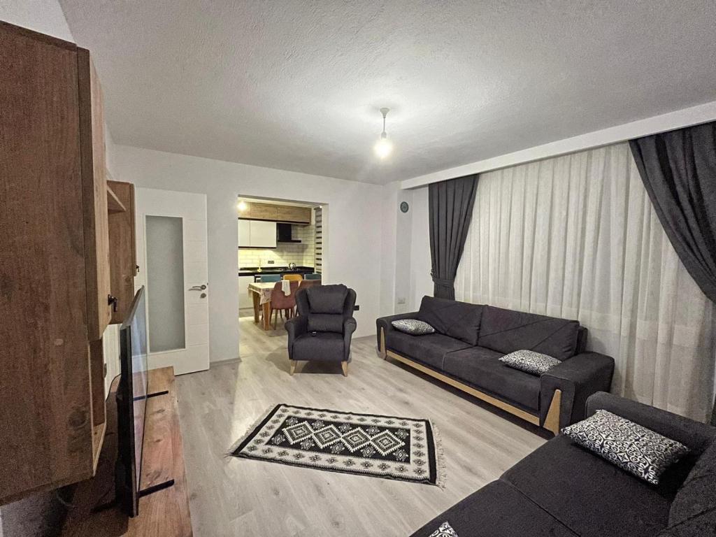 a living room with a couch and a chair at Kırevi-Airport in Ortaca