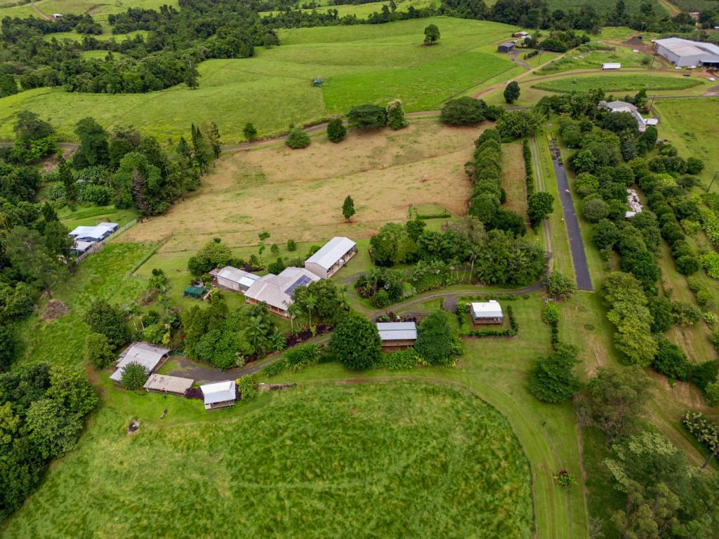 an aerial view of a farm with buildings and trees at Mena Creek Flower House in Mena Creek