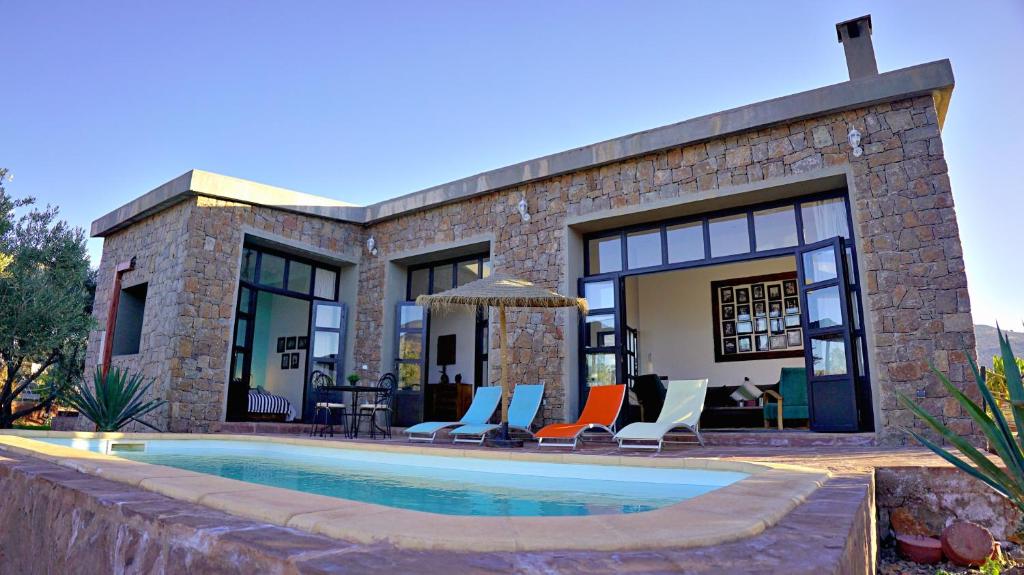 a house with a swimming pool in front of it at Soo Bin in Bine el Ouidane