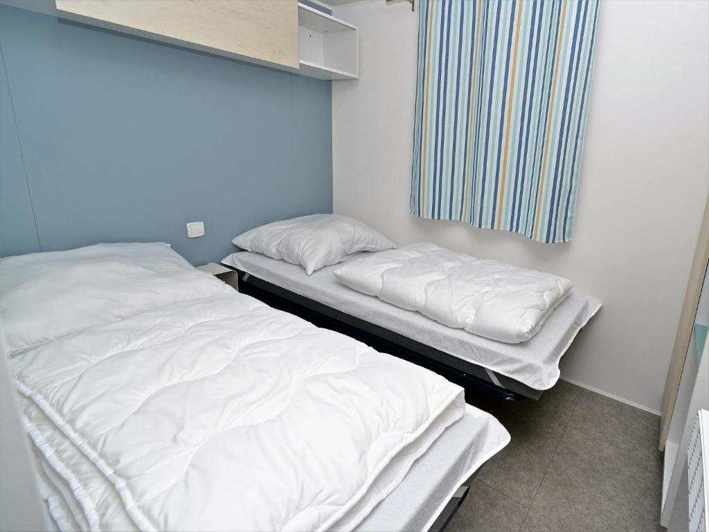 Postel nebo postele na pokoji v ubytování Mobile Home an der Drau