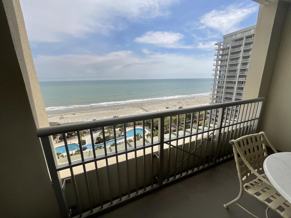 a balcony with a view of the beach and ocean at Direct ocean front condo in Royale Palms, 801 condo in Coffeyville