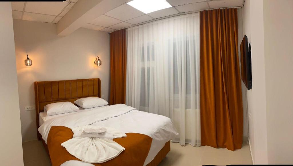 a bedroom with a bed and a window at Kadıköy Bull Hotel in Istanbul
