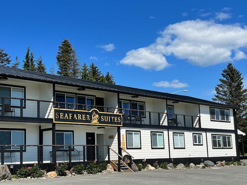 a large white building with a sign on it at Seafarer Suites in Homer
