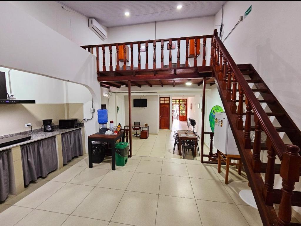 a kitchen with a staircase and a living room at 3F Apartments in Leticia