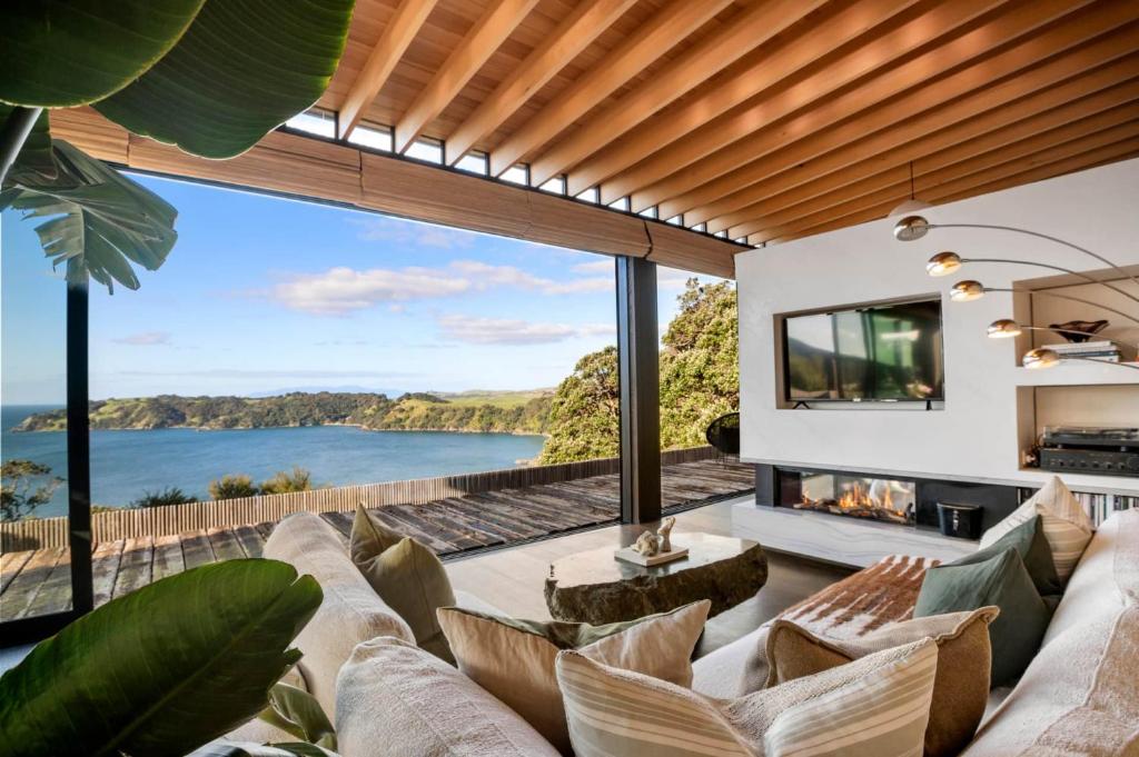 an open living room with a view of the ocean at The Escape on Belle - Coast & Country in Onetangi