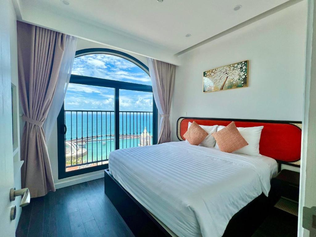 1 dormitorio con cama y ventana grande en Harry Phu Quoc Hotel 3, en Phu Quoc