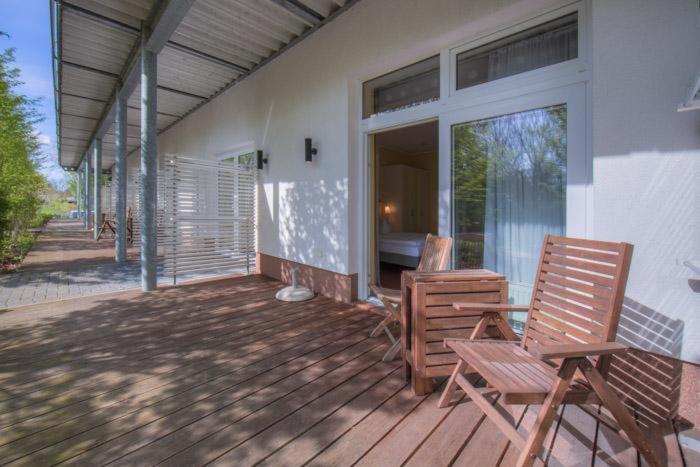 a porch with two chairs on a house at Strandläufer 111 in Granzow