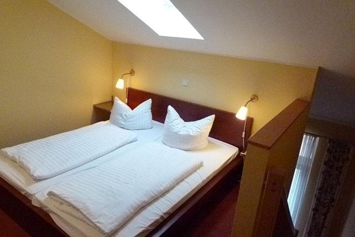 a bedroom with two beds with white pillows at Schneeeule 222 in Granzow