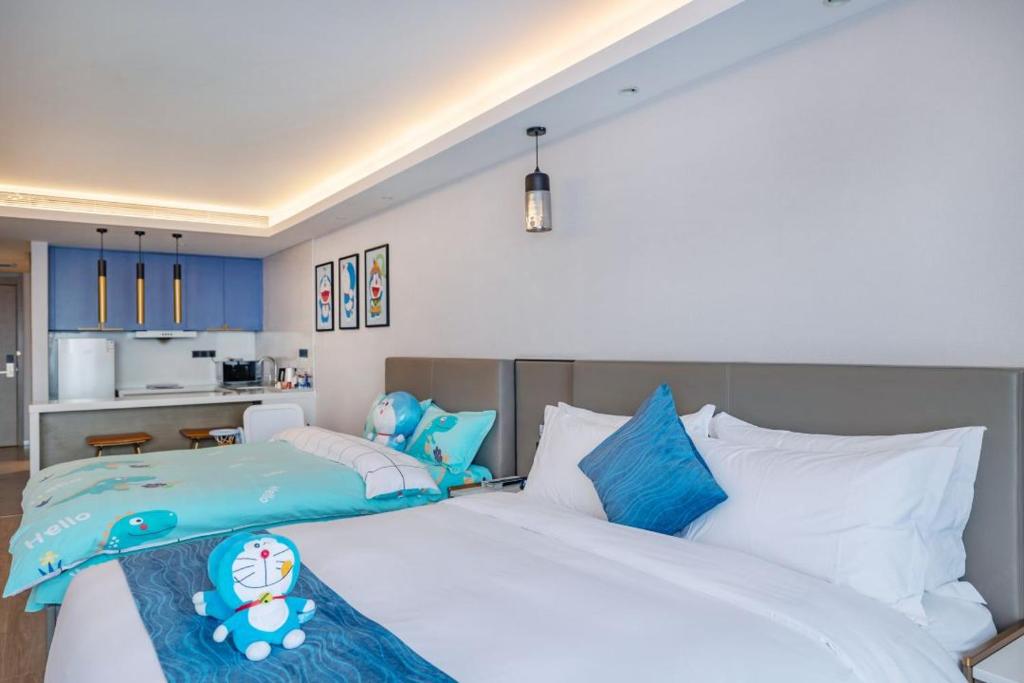 Postel nebo postele na pokoji v ubytování Changsha Zealandia Serviced Apartment