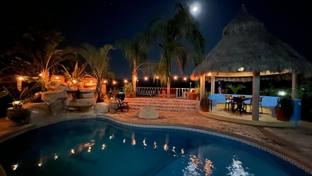 a swimming pool at night with a gazebo at Villas Chulavista in Sayulita
