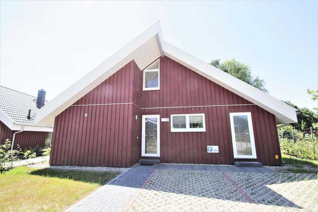a red house with a white roof at Seeschwalbe Classic 322 in Mirow