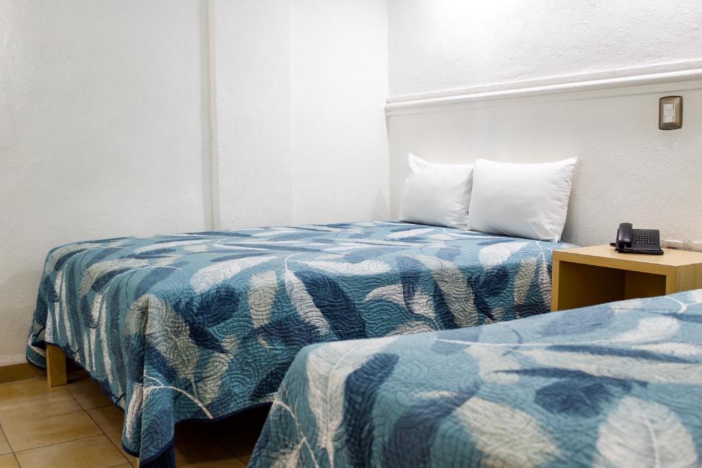 Postel nebo postele na pokoji v ubytování Hotel Nueva Zelanda