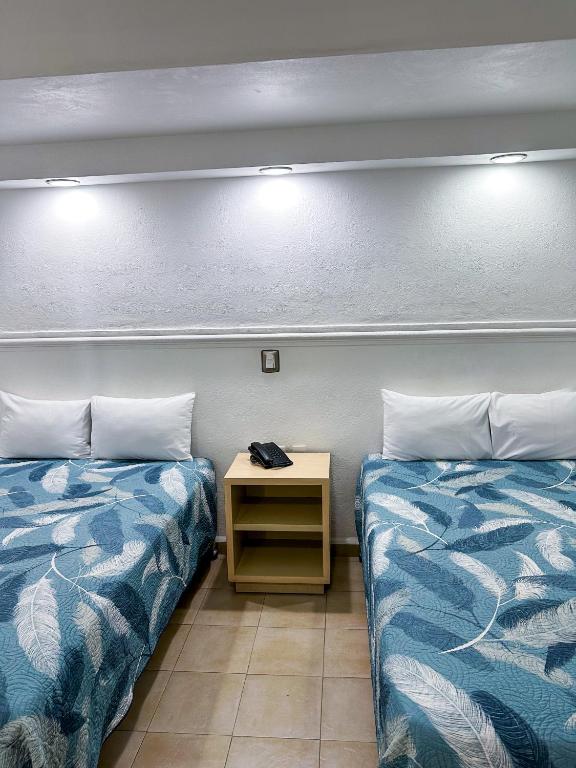 Postel nebo postele na pokoji v ubytování Hotel Nueva Zelanda