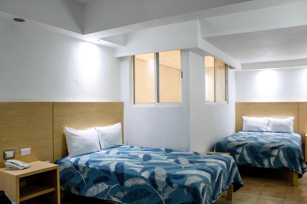 Postel nebo postele na pokoji v ubytování Hotel Nueva Zelanda