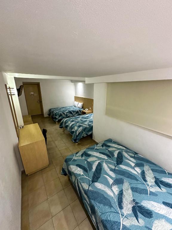 Postel nebo postele na pokoji v ubytování Hotel Nueva Zelanda