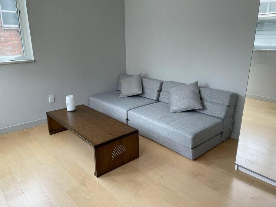 a living room with a couch and a coffee table at Seattle Skyline Retreat Cozy 1BD w Balcony Views in Seattle