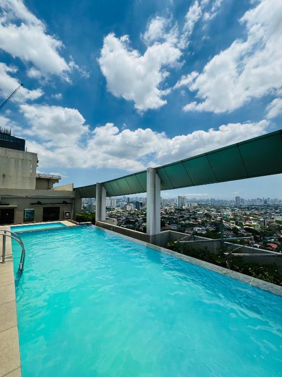 a swimming pool on the roof of a building at Vinia Infinity Studio 1 Near Malls with WiFi and Netflix in Manila