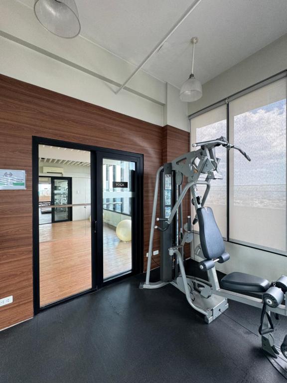 a room with a gym with a tread machine and a treadmill at Vinia Infinity Studio 1 Near Malls with WiFi and Netflix in Manila