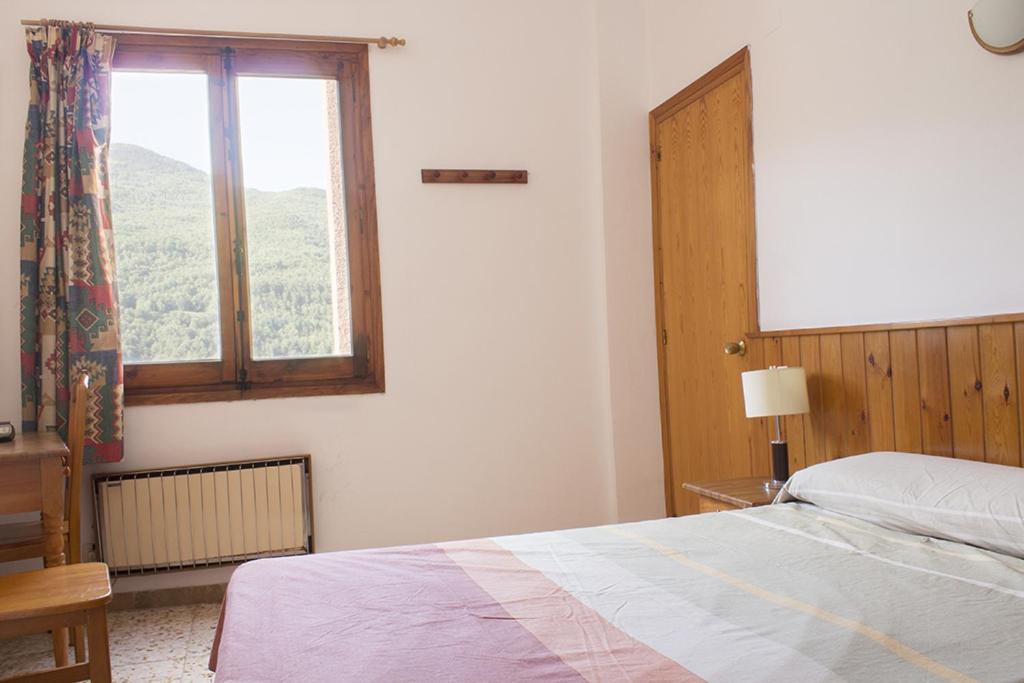 A bed or beds in a room at Apartamentos Grist