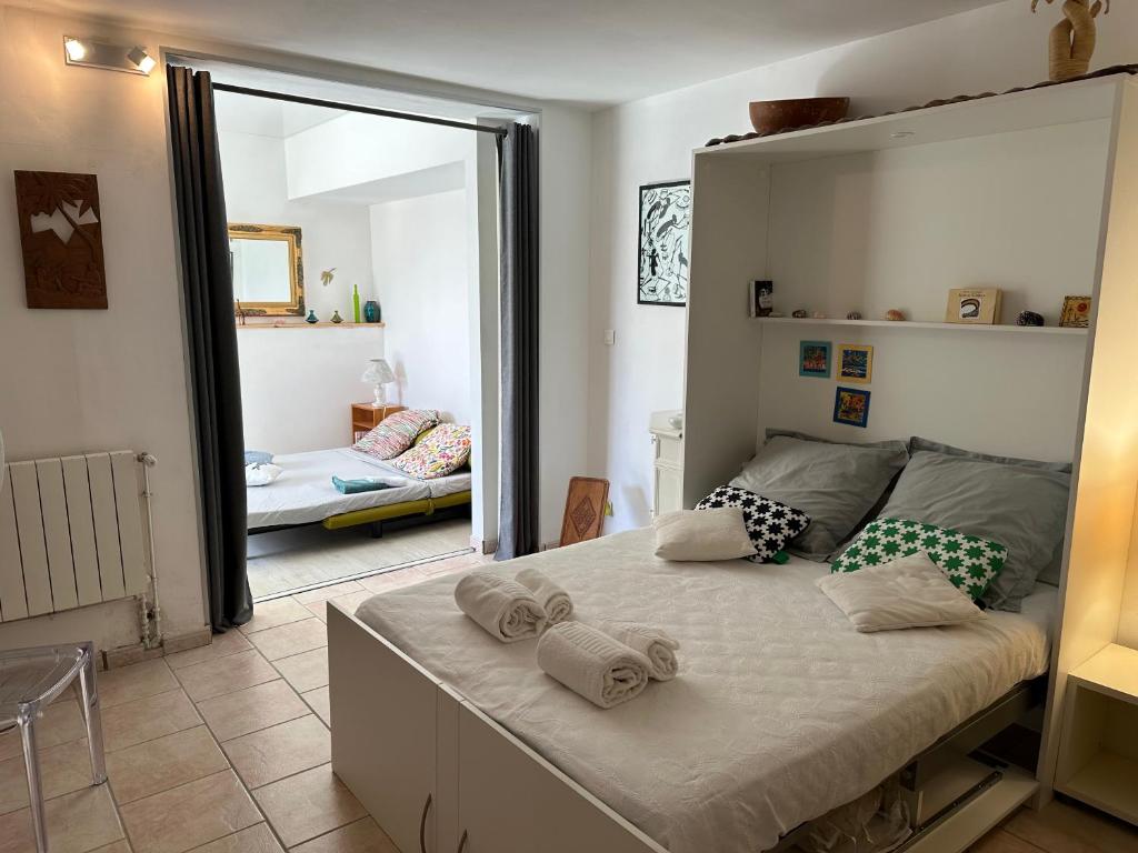 a bedroom with a large bed with towels on it at FLC-Sea View-Jacuzzi-3 Bedrooms-8p-Parking for 2 cars in Marseille