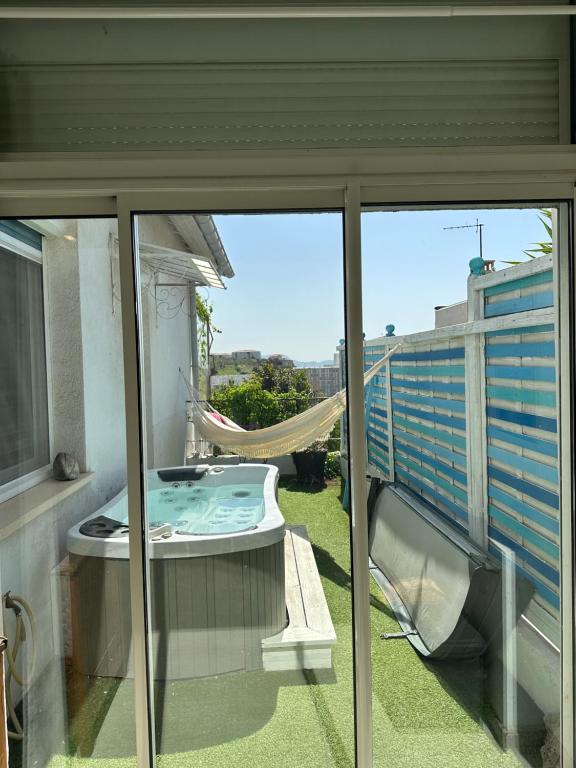 a balcony with a hammock and a view of a building at FLC-Sea View-Jacuzzi-3 Bedrooms-8p-Parking for 2 cars in Marseille