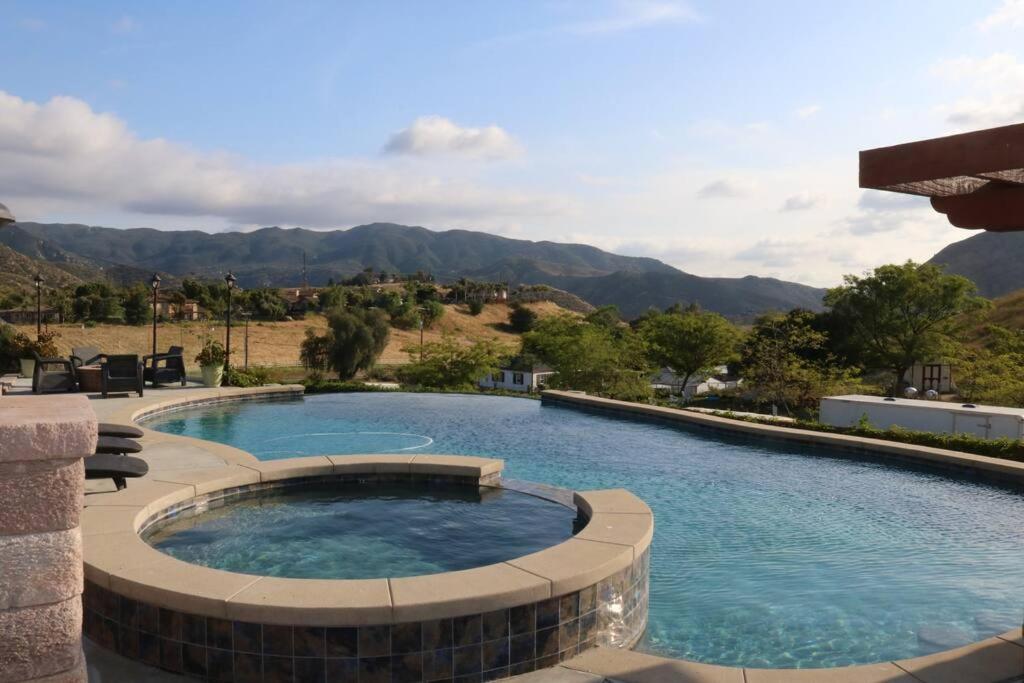 a large swimming pool with a large poolvisor at Home with Infinity Pool and Mountain View in El Cajon