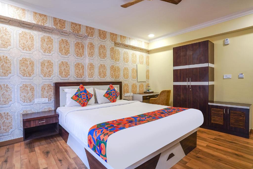 a bedroom with a large white bed in a room at FabHotel Prime Signature Inn in Bangalore