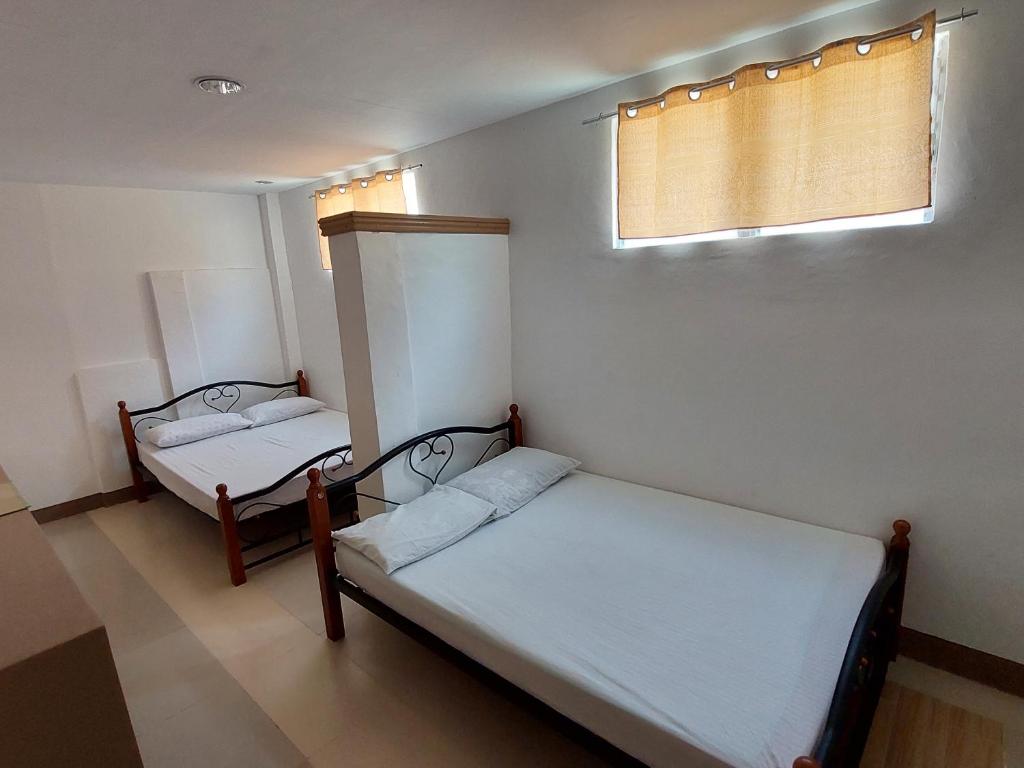 Postel nebo postele na pokoji v ubytování Yuken Mari Beach Resort Panglao