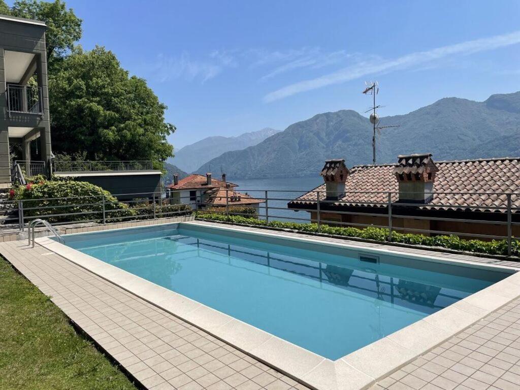 a swimming pool on a house with a view of the water at Acqua Dolce Comfortable holiday residence in Sala Comacina