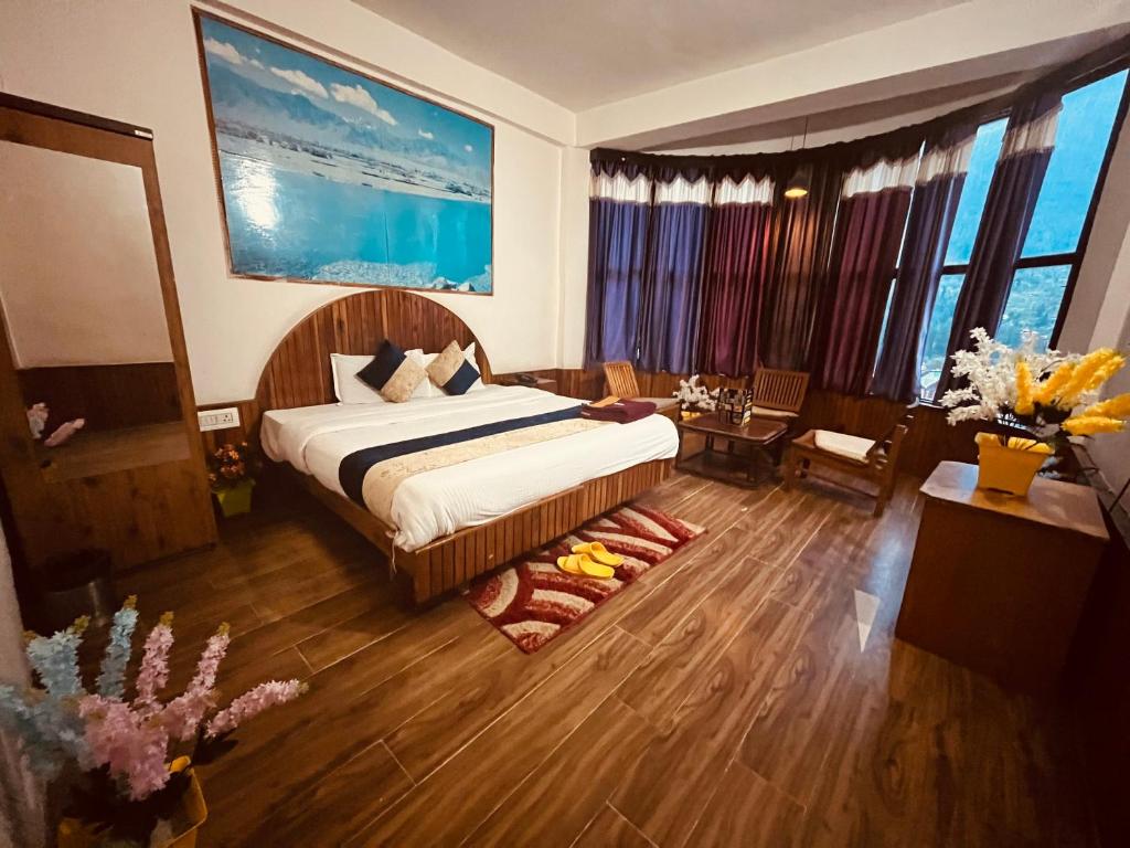 a hotel room with a bed and a living room at Gangari Home stay in Bharūch