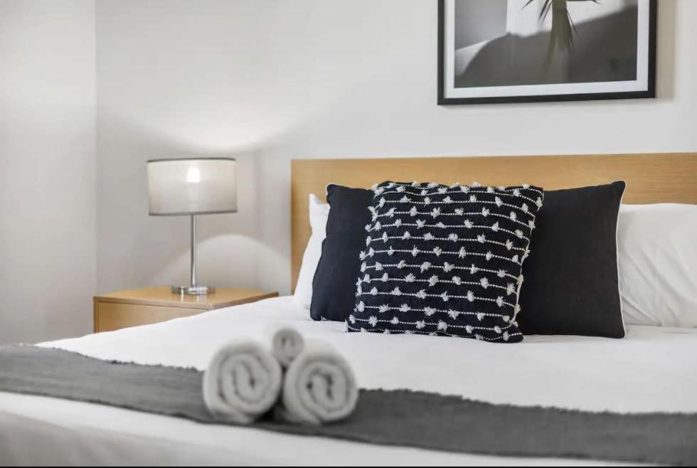 a bedroom with a bed with two towels on it at Executive Apt - 2BR 1BA w Parking in Perth