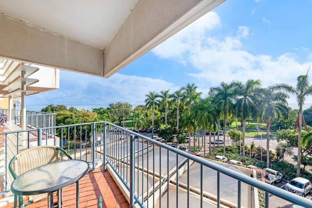 a balcony with two chairs and a view of a street at Idyllic Waterfront Pool Escape with Esplanade View in Darwin